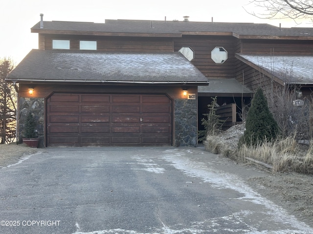 view of garage at dusk