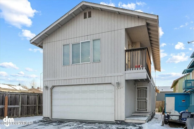 view of front of home featuring a balcony and a garage