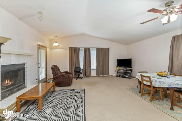 carpeted living room with ceiling fan, lofted ceiling, and a fireplace