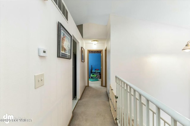 hallway featuring light colored carpet