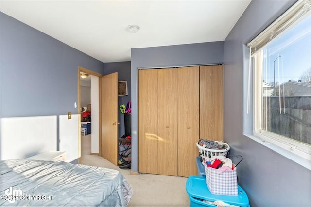 carpeted bedroom featuring a closet