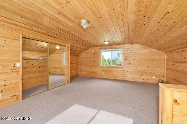 additional living space with wood walls, lofted ceiling, carpet floors, and wooden ceiling