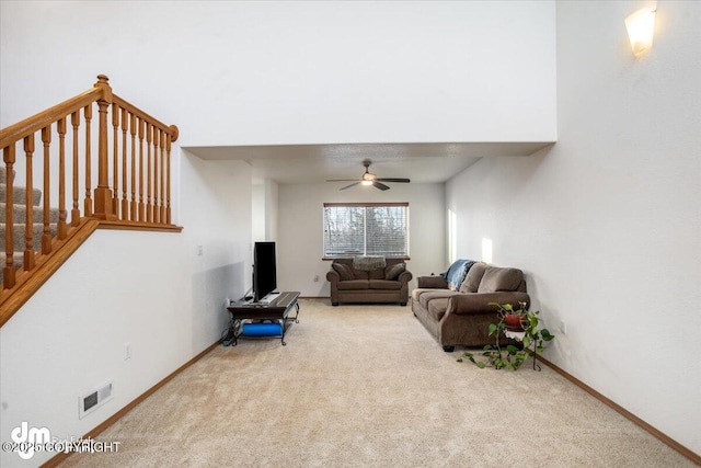 carpeted living room featuring ceiling fan