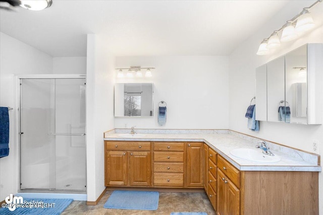 bathroom featuring vanity and a shower with shower door