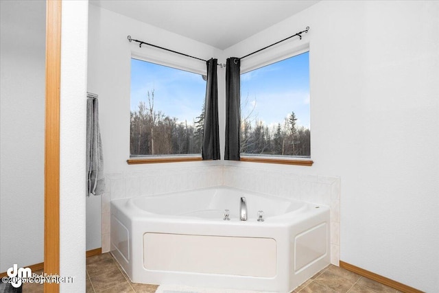 bathroom featuring a healthy amount of sunlight and a bathtub