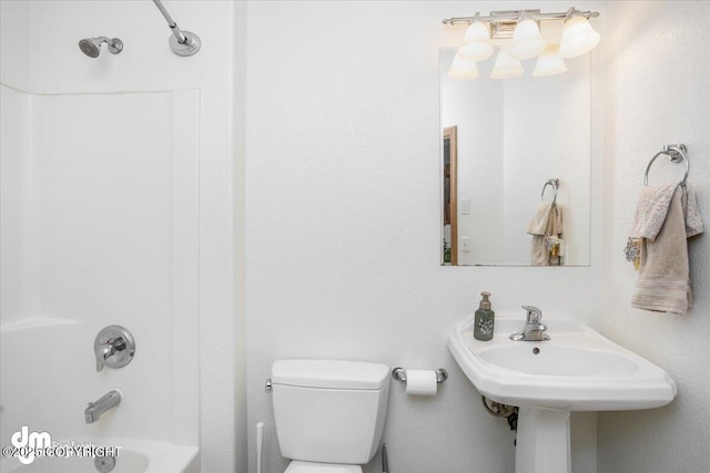 bathroom featuring shower / washtub combination and toilet