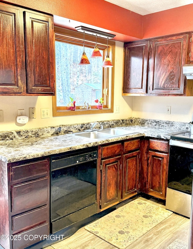 kitchen with electric stove, black dishwasher, pendant lighting, light wood-style flooring, and a sink