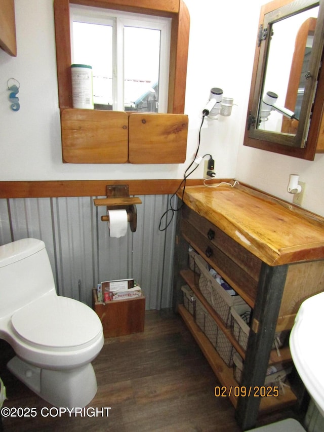 bathroom with hardwood / wood-style flooring and toilet