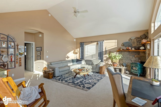carpeted living room featuring ceiling fan and high vaulted ceiling