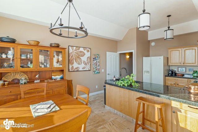 dining area with sink and vaulted ceiling