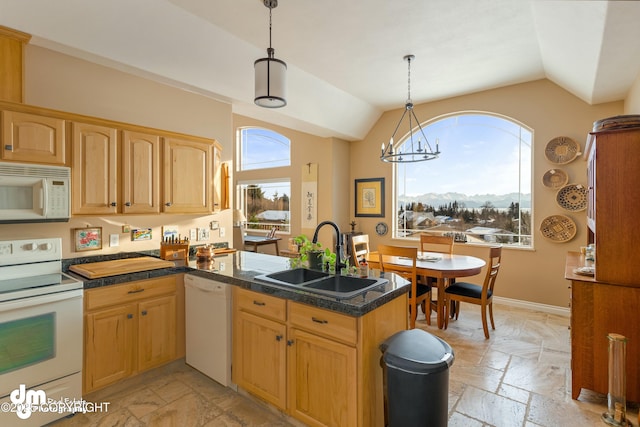 kitchen with sink, pendant lighting, white appliances, and kitchen peninsula