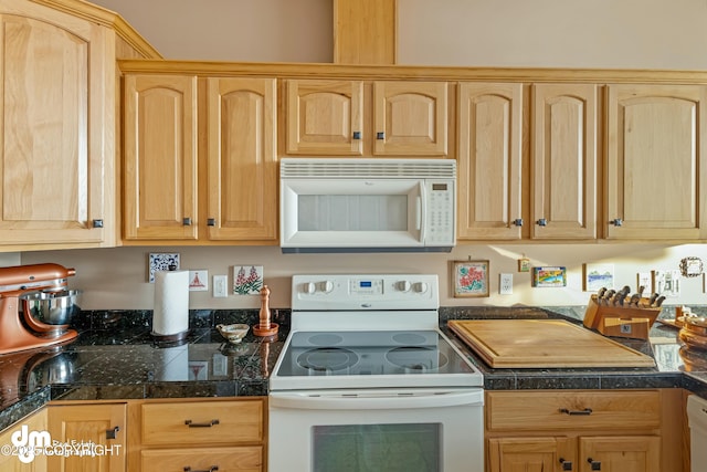 kitchen featuring light brown cabinetry and white appliances