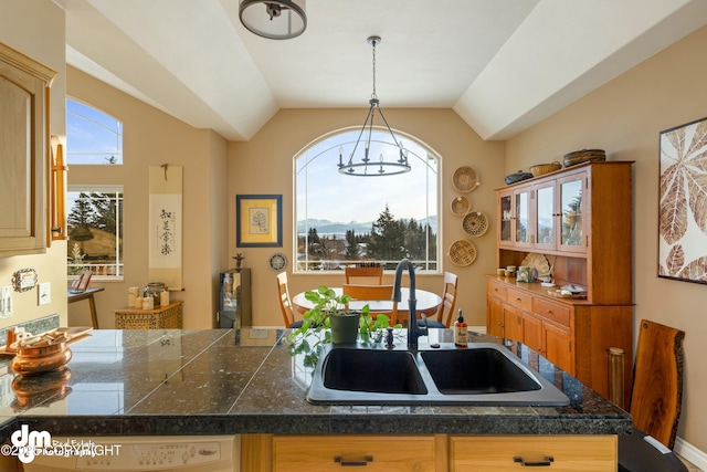 kitchen with lofted ceiling, sink, and decorative light fixtures