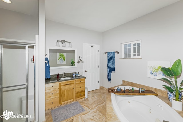 bathroom with vanity and independent shower and bath