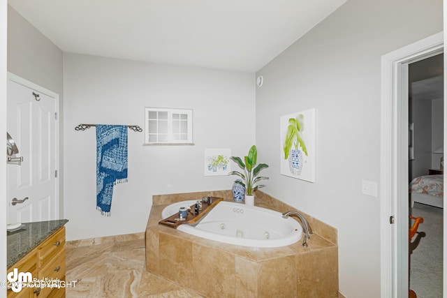 bathroom with vanity and tiled tub