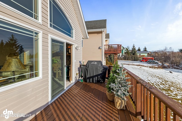 snow covered deck with area for grilling