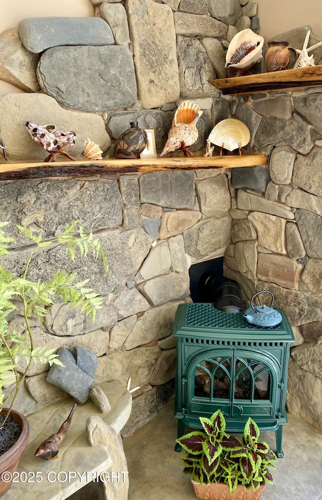 interior details featuring concrete flooring and a wood stove