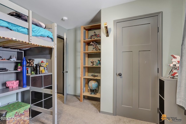 bedroom featuring light colored carpet