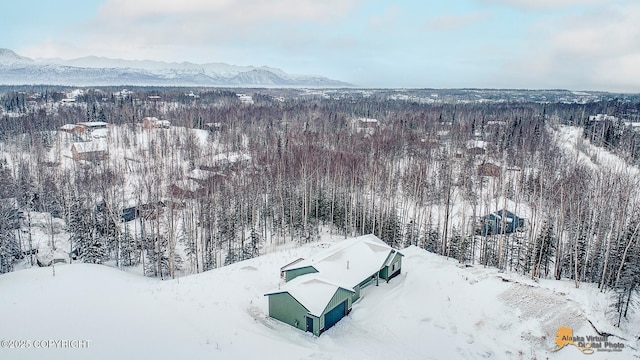 snowy aerial view with a mountain view