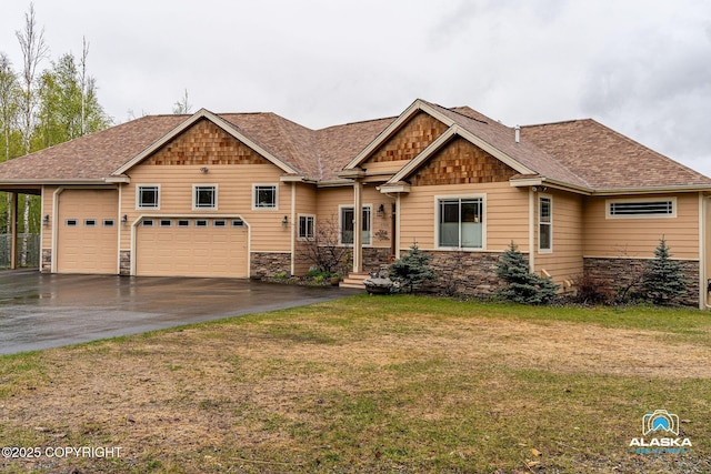 craftsman inspired home with stone siding, driveway, a front lawn, and roof with shingles