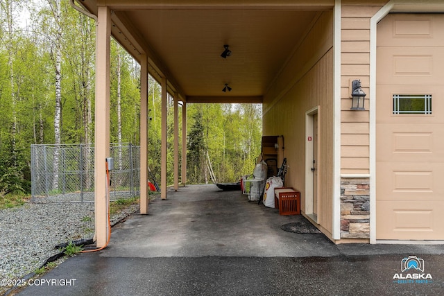 view of patio featuring fence and a forest view