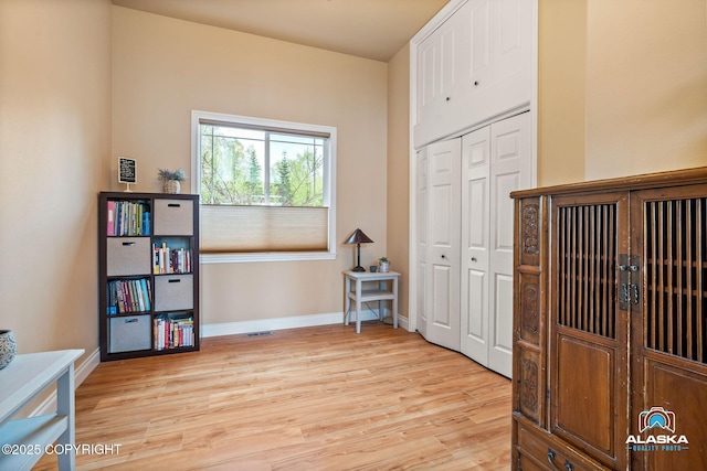 home office with light wood-type flooring and baseboards