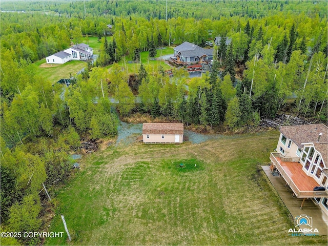 view of subject property featuring a heavily wooded area