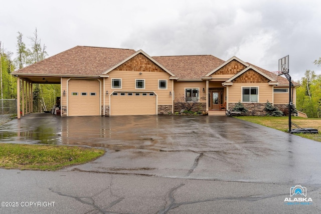 craftsman-style house with driveway, stone siding, and a garage