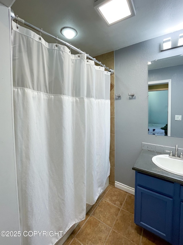 full bath with vanity, a shower with shower curtain, and tile patterned floors