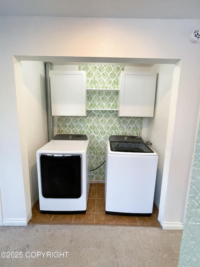 laundry room featuring separate washer and dryer, carpet, cabinet space, and baseboards