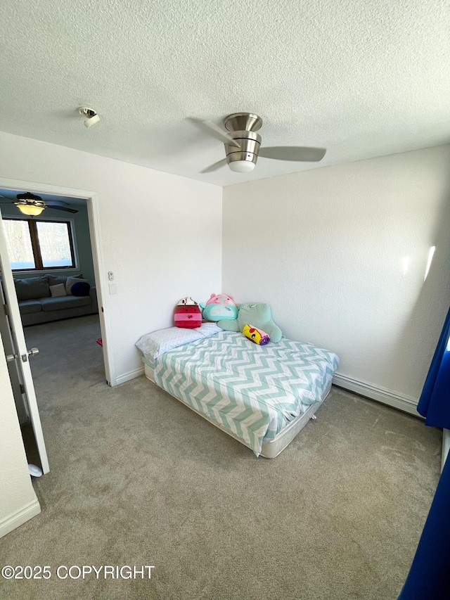 carpeted bedroom with a baseboard radiator, a textured ceiling, baseboards, and a ceiling fan