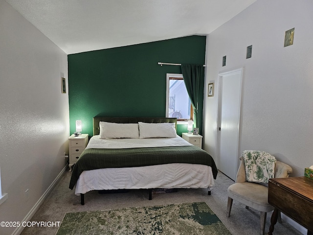 carpeted bedroom featuring lofted ceiling and baseboards