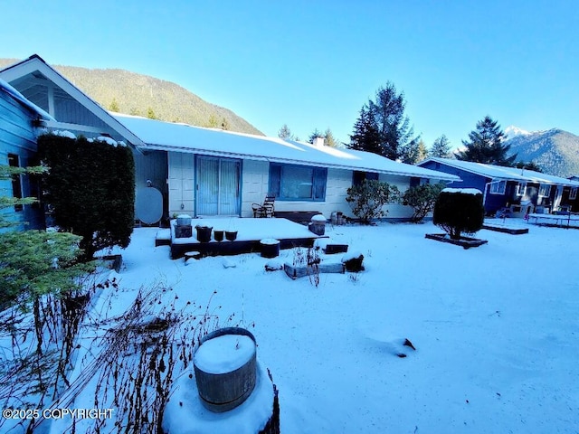 snow covered property with a mountain view