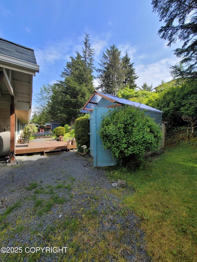 223 Lakeview Dr, Sitka, AK 99835 - view of yard featuring a storage unit, a wooden deck, and oil tank