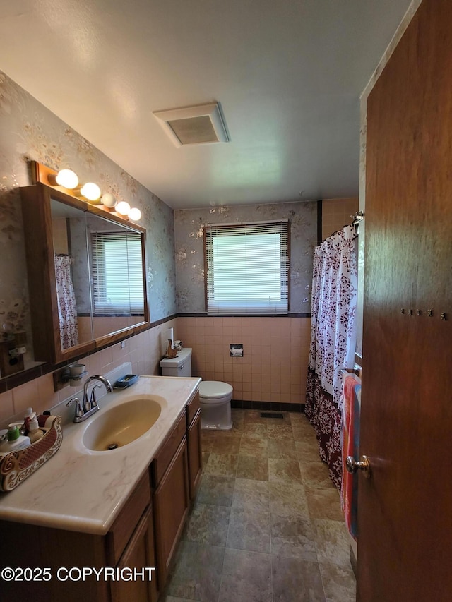 223 Lakeview Dr, Sitka, AK 99835 - bathroom with vanity, tile walls, curtained shower, and a wainscoted wall