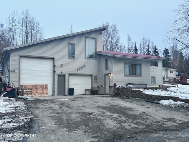 12421 Silver Spruce Dr, Anchorage, AK 99516 - snow covered back of property with driveway and a garage