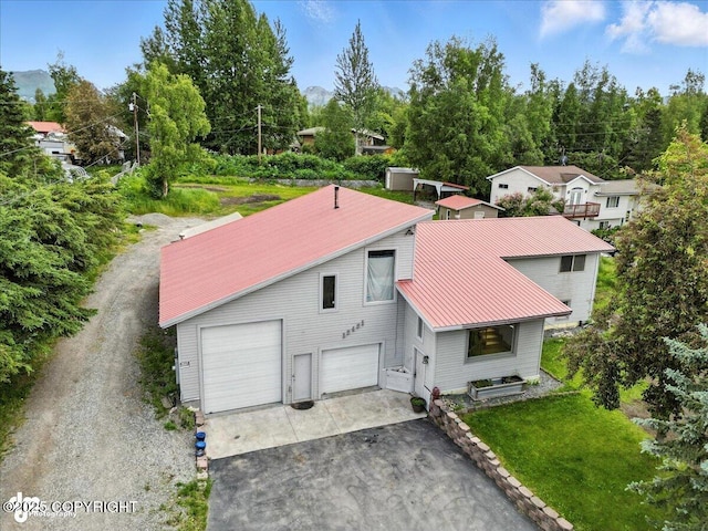 12421 Silver Spruce Dr, Anchorage, AK 99516 - view of front of property with driveway, a metal roof, and a garage