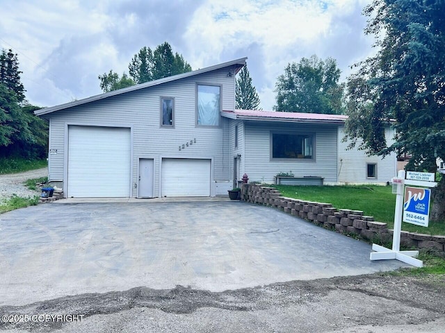 12421 Silver Spruce Dr, Anchorage, AK 99516 - tri-level home featuring a front yard, asphalt driveway, a garage, and a metal roof