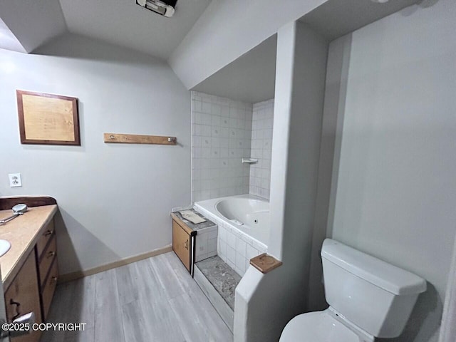 12421 Silver Spruce Dr, Anchorage, AK 99516 - full bathroom featuring wood finished floors, tiled tub, vanity, and lofted ceiling