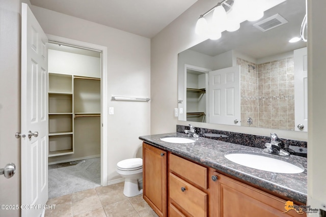 full bathroom with tile patterned flooring, visible vents, a sink, and a spacious closet