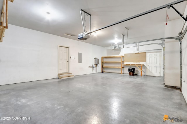 garage featuring electric panel and a garage door opener