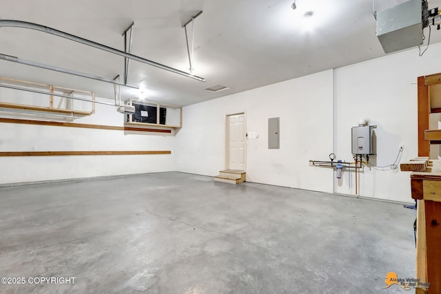 garage featuring tankless water heater and electric panel