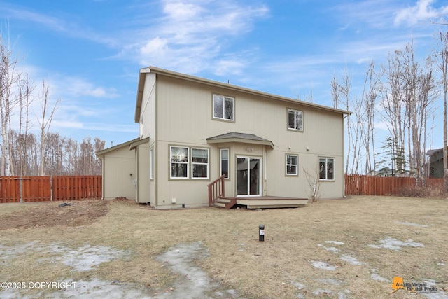 rear view of property featuring fence