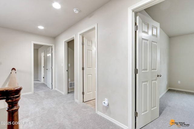 hall featuring recessed lighting, light colored carpet, and baseboards