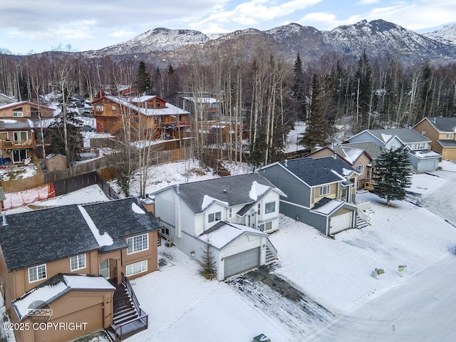 snowy aerial view featuring a mountain view