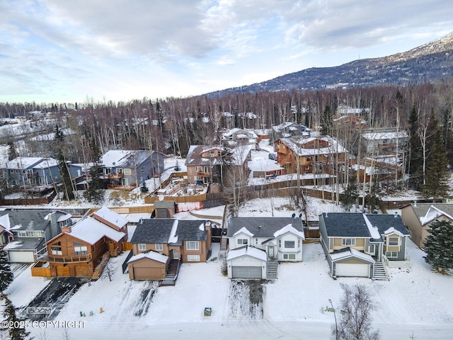 snowy aerial view featuring a mountain view