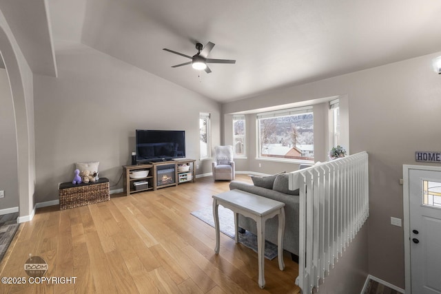 living room with vaulted ceiling, ceiling fan, and light hardwood / wood-style floors