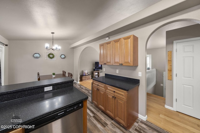 kitchen featuring dishwasher, an inviting chandelier, dark hardwood / wood-style flooring, and decorative light fixtures