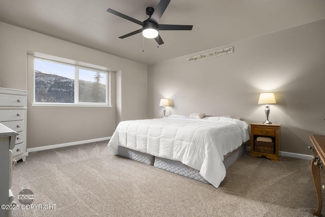 carpeted bedroom with a mountain view and ceiling fan