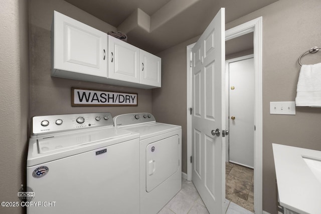 washroom featuring cabinets and washer and dryer